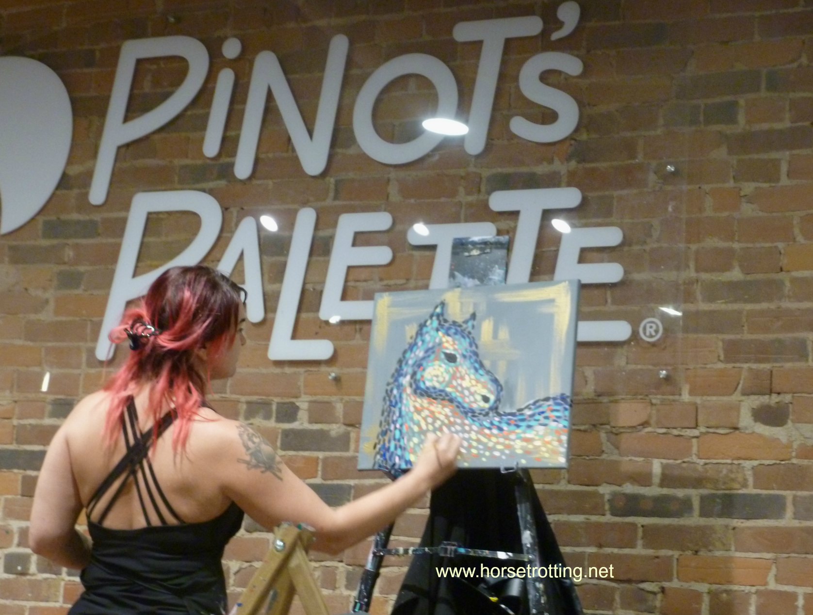 instructor painting horse at pinot's palette